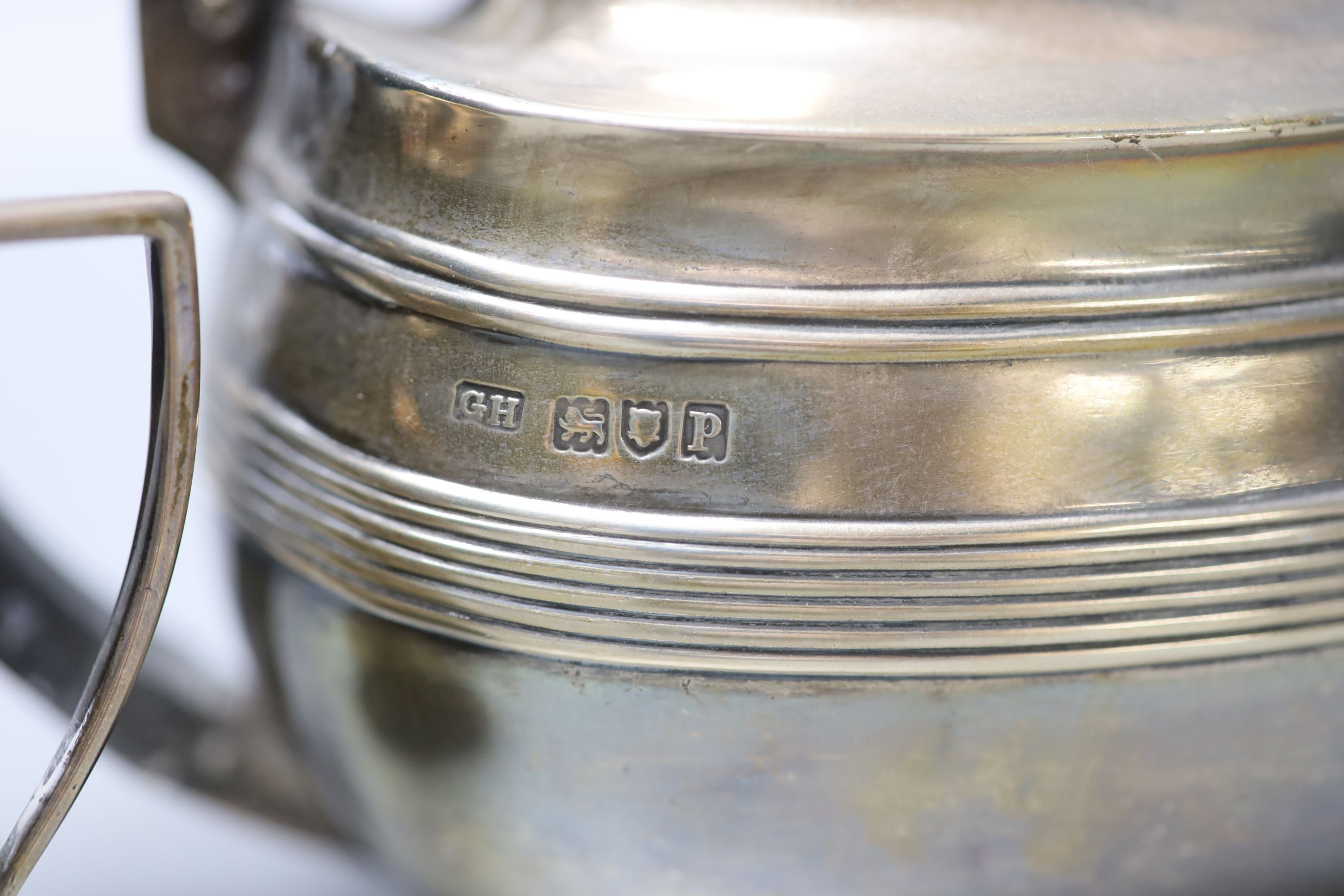 A George V reeded silver oval three piece tea set, George Howson, London, 1910, gross 16oz.